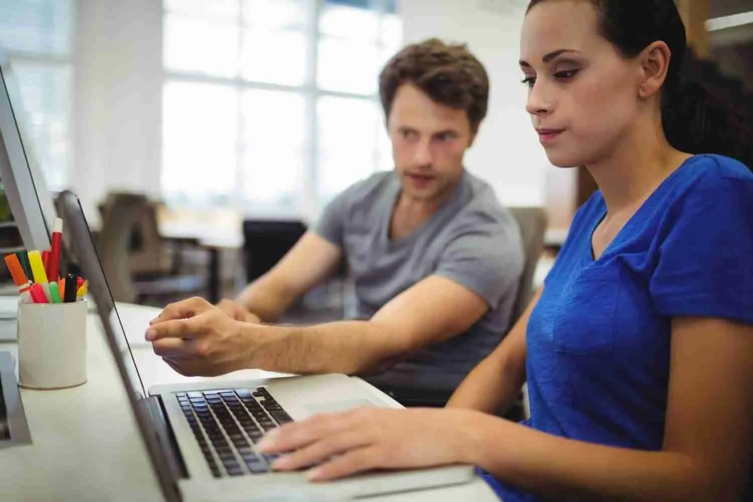business-executives-discussing-laptop | MacSolutions Plus Buffalo's local Apple Authorized Service Center