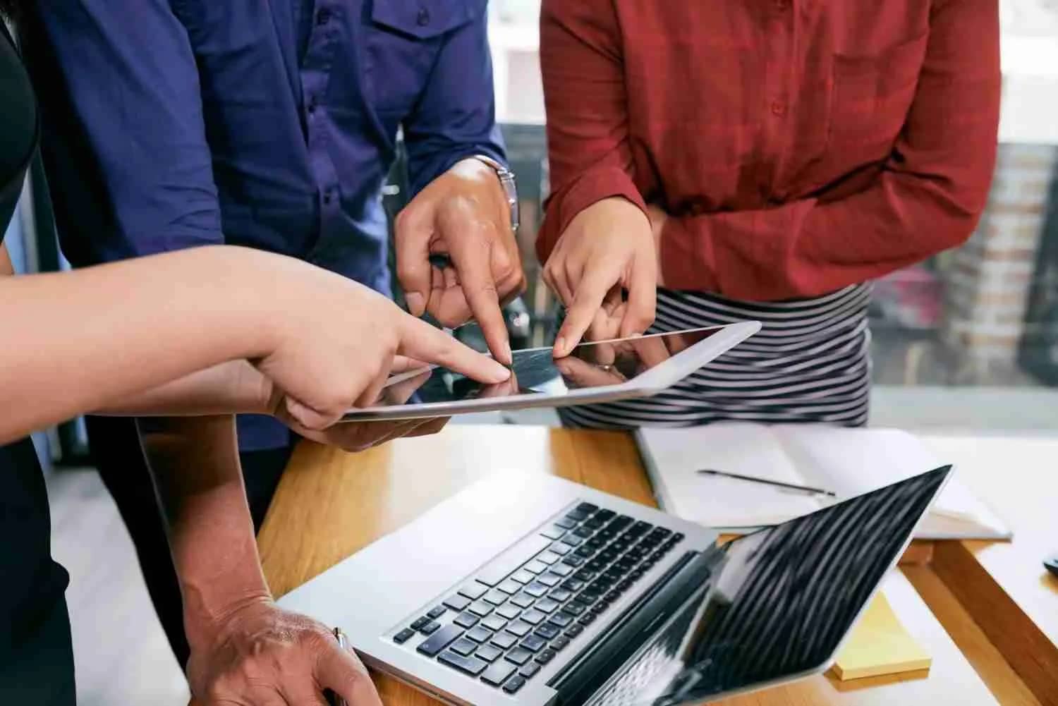 business-people-pointing-tablet | MacSolutions Plus Buffalo's local Apple Authorized Service Center