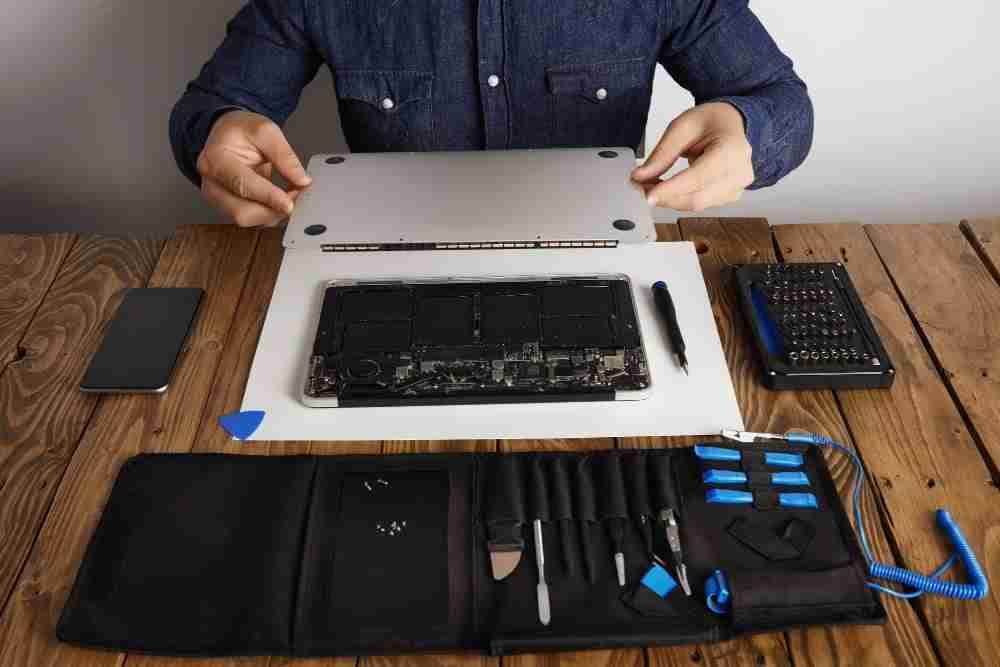 cleaning-fixing-it-with-his-professional-tools-from-toolkit-box-near-wooden-table-front-view | MacSolutions Plus Buffalo's local Apple Authorized Service Center